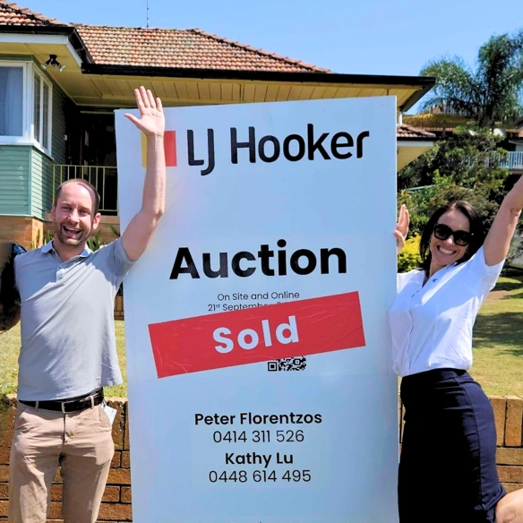Successful Brisbane property auction with sold sign.