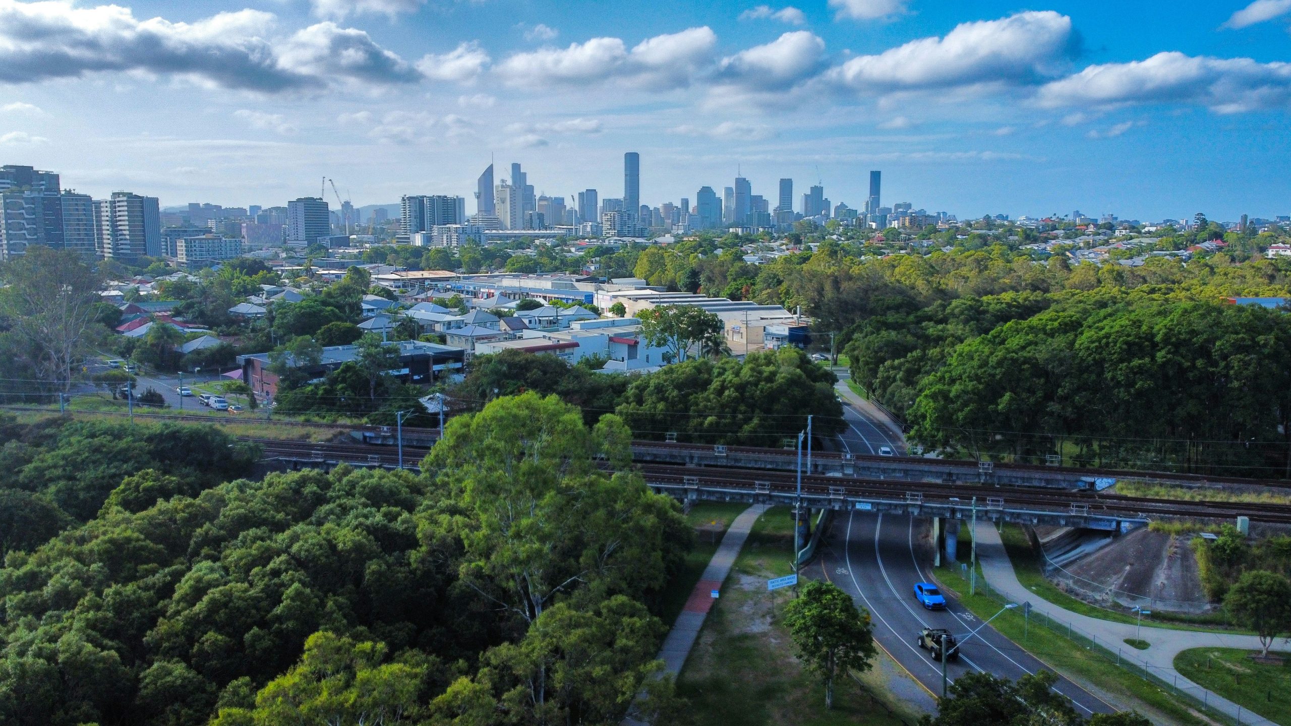 Aerial view of Brisbane skyline with lush greenery and urban landscape as The Gap Suburb representation.