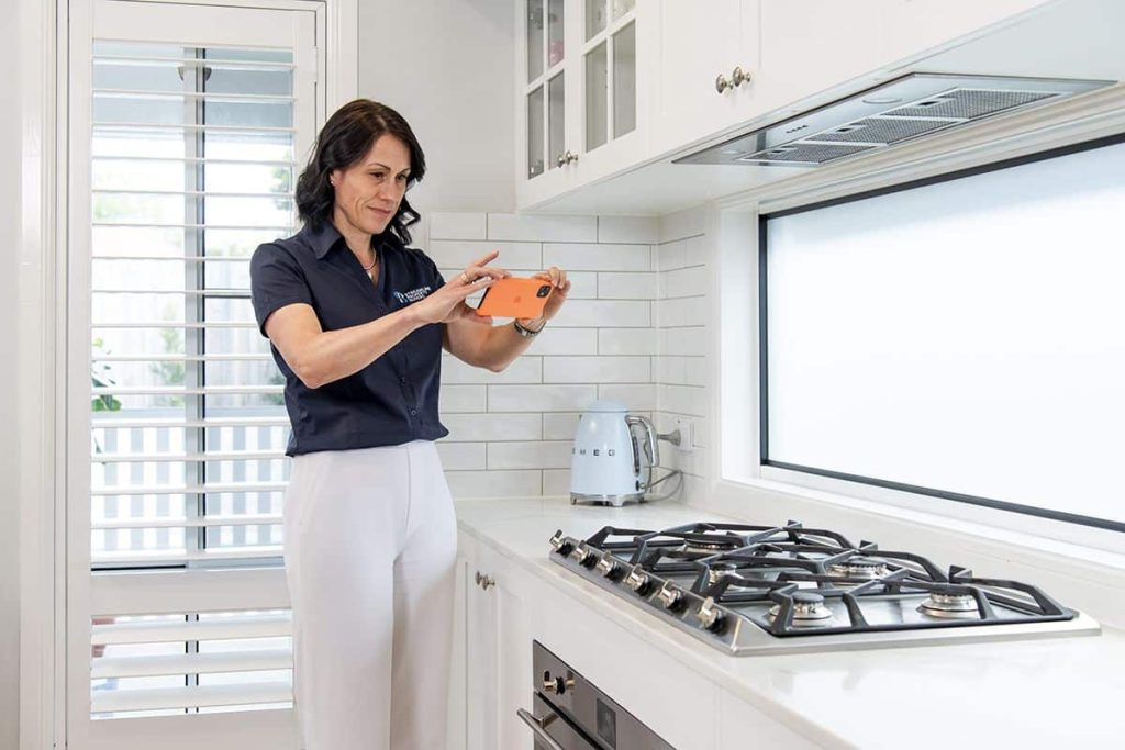 Buyer’s agent inspecting kitchen features during a home property inspection.